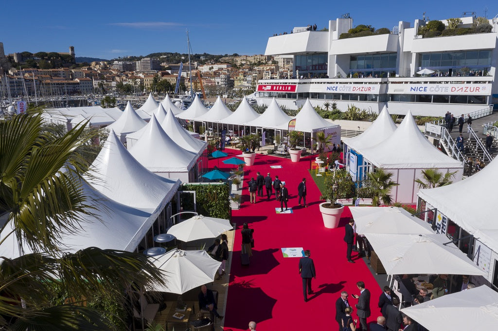 Palais des Festivals exterior with congress tents. Experience seamless transportation to your next business event with our luxury chauffeur service in Cannes.